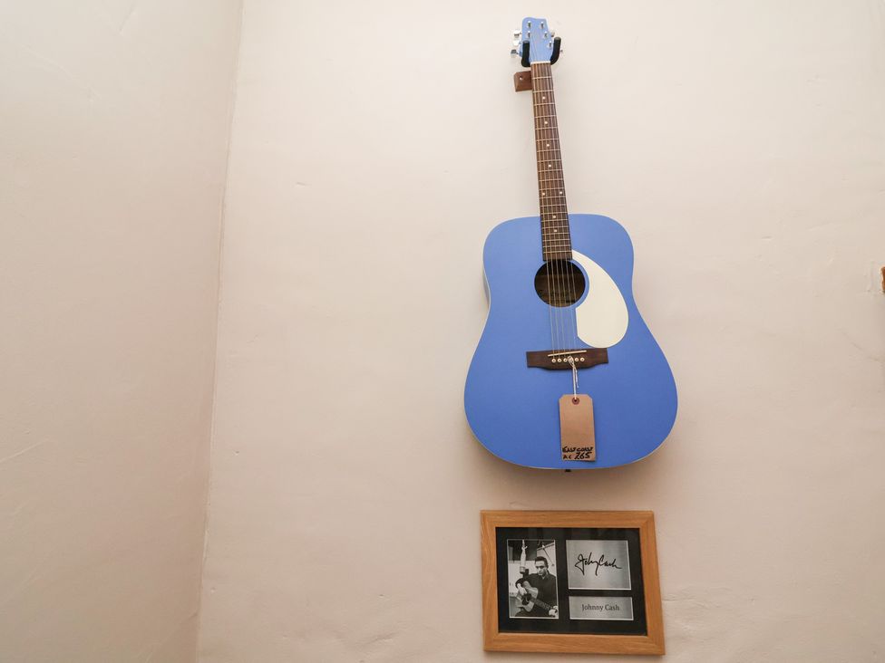 A blue guitar and a framed picture of Johnny Cash at The Ranch Prestatyn