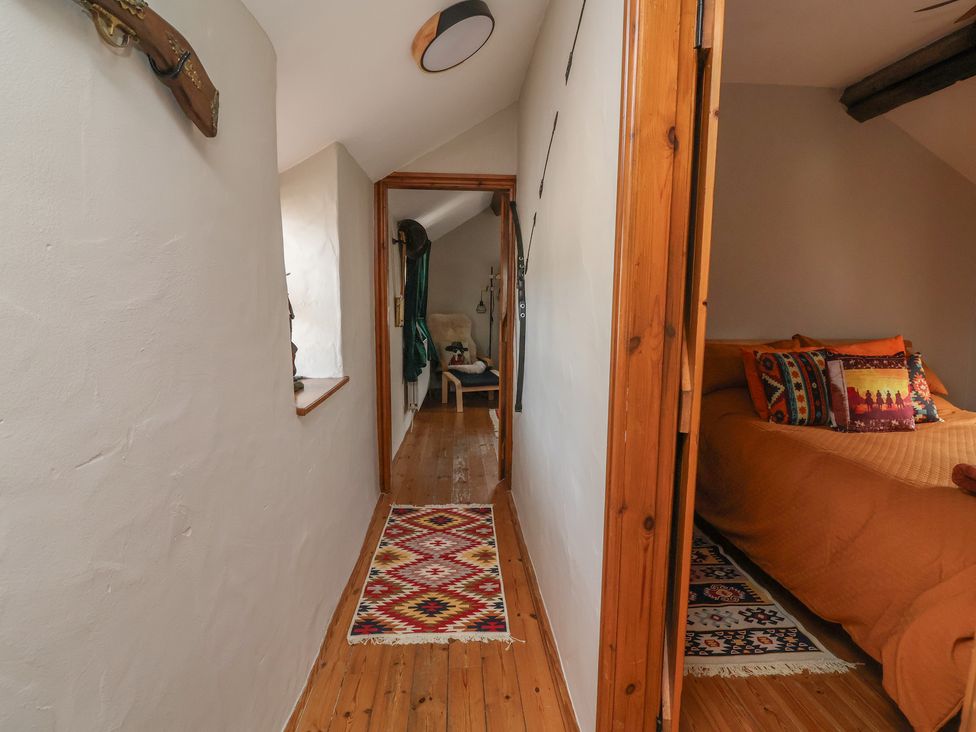 A hallway with a bed and decor at The Ranch in Prestatyn