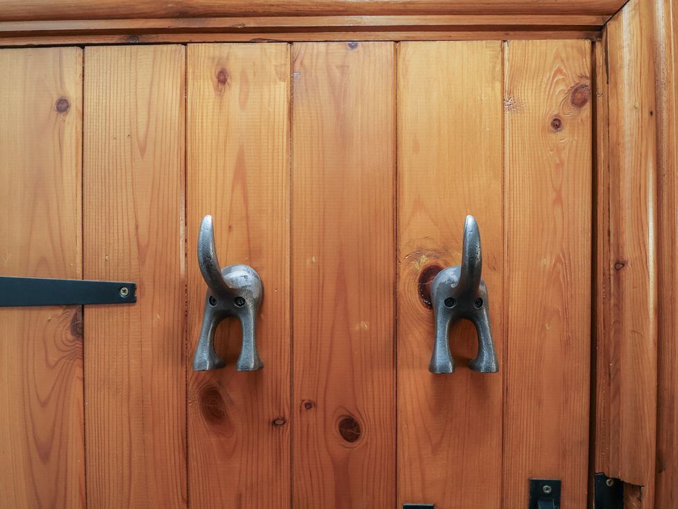 Metal hooks shaped like elephants on a wooden door at The Ranch in Prestatyn