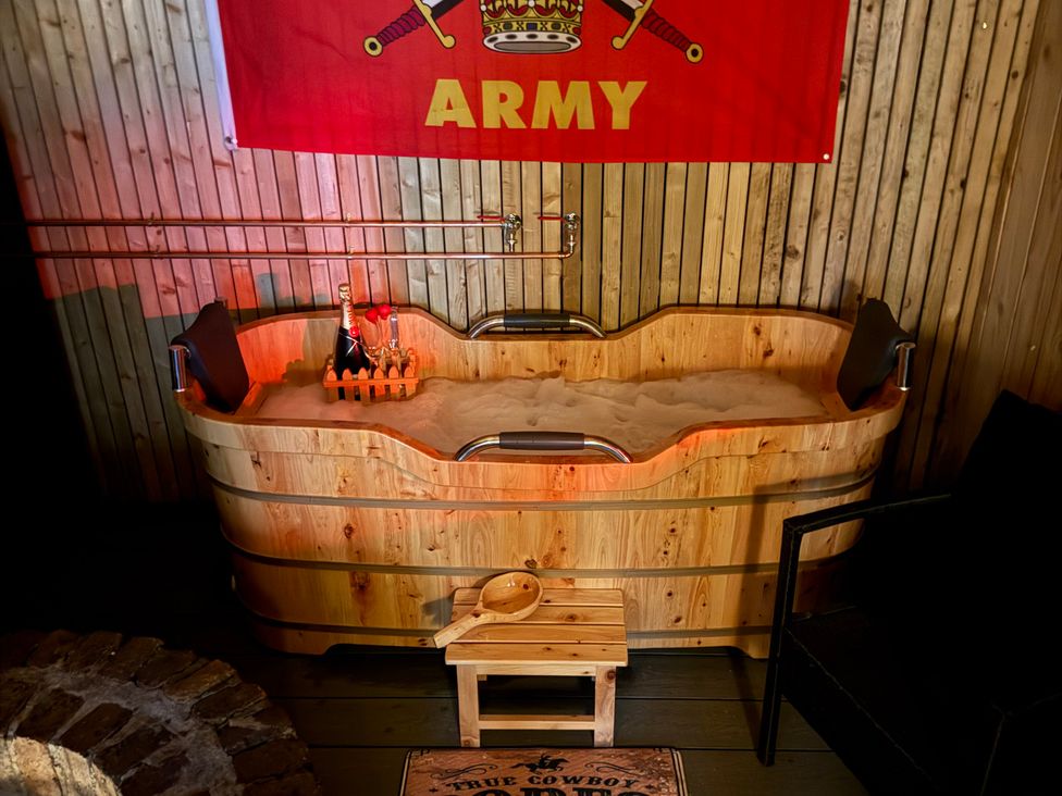 A wooden bathtub with bottles and a flag at The Ranch in Prestatyn