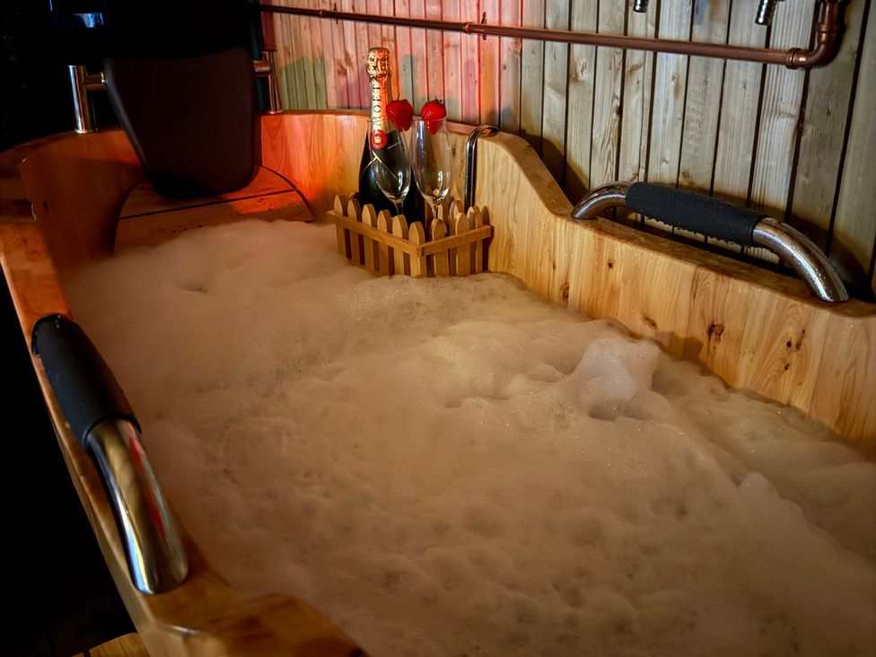 A bathtub with bubbles and champagne at The Ranch in Prestatyn