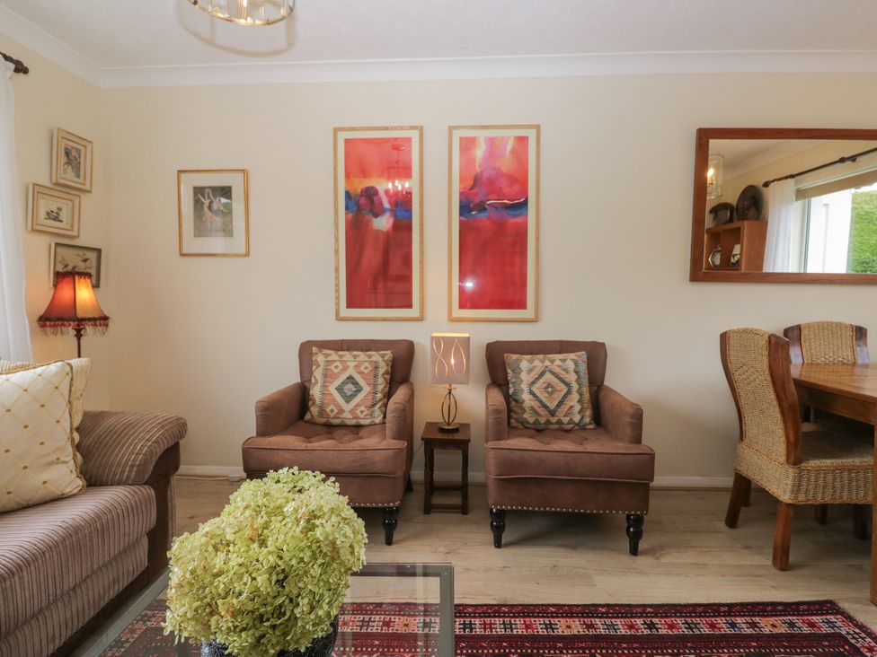 A living room with a sofa and artwork at Apple Byrd in Kendal