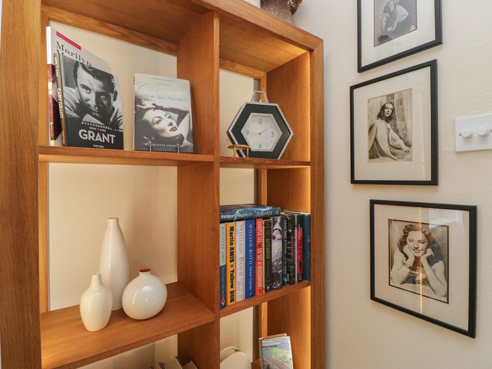 A bookshelf with books and decorative items at Apple Byrd in Kendal