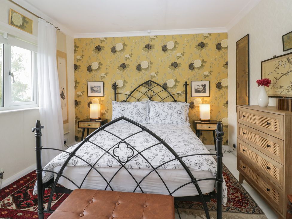 A bedroom with a bed and nightstand at Apple Byrd in Kendal