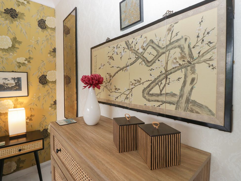 A hallway with wall art and decorative items at Apple Byrd in Kendal