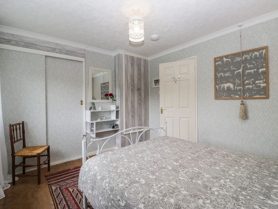 A bedroom with a bed and chair at Apple Byrd in Kendal