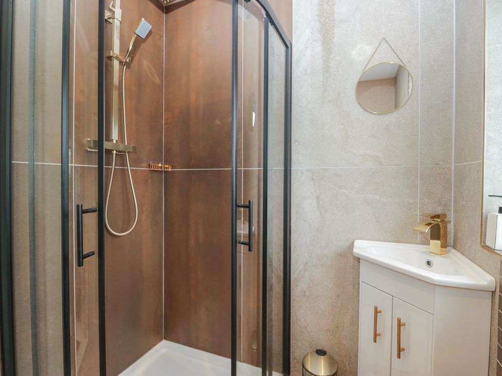 A bathroom with a shower and sink at Apple Byrd in Kendal