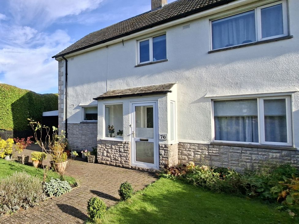 A house with a front porch and garden at Apple Byrd in Kendal