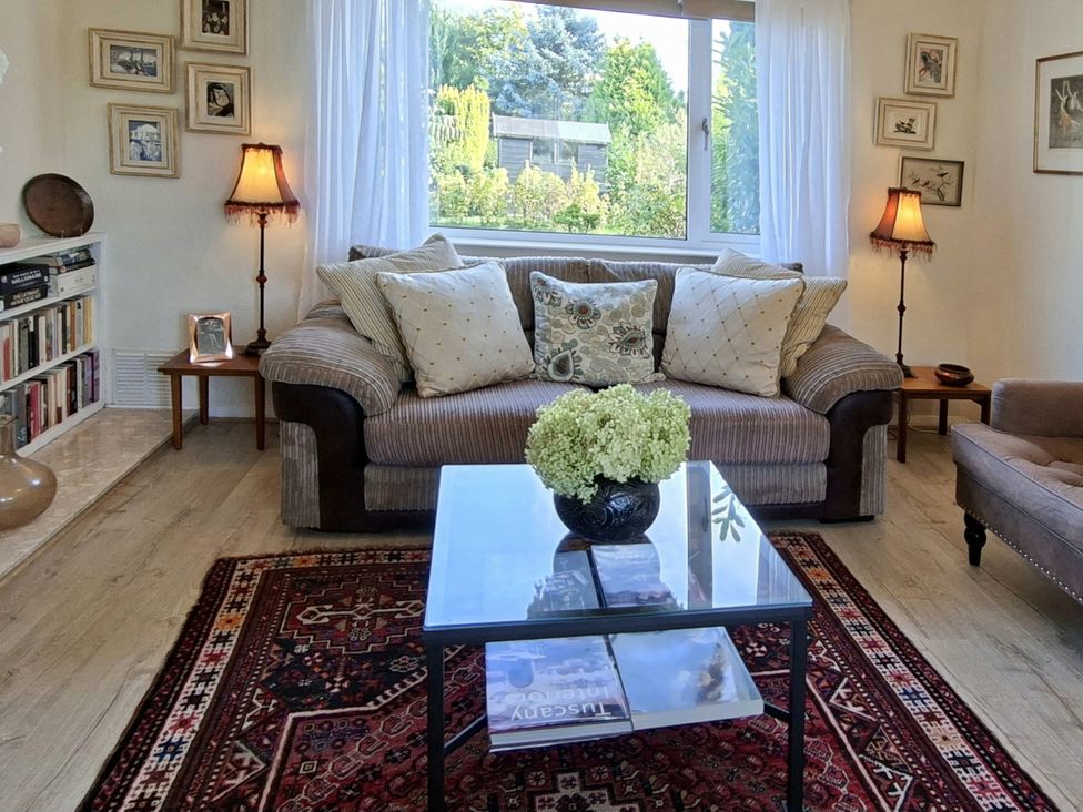 A living room with a sofa and table at Apple Byrd in Kendal