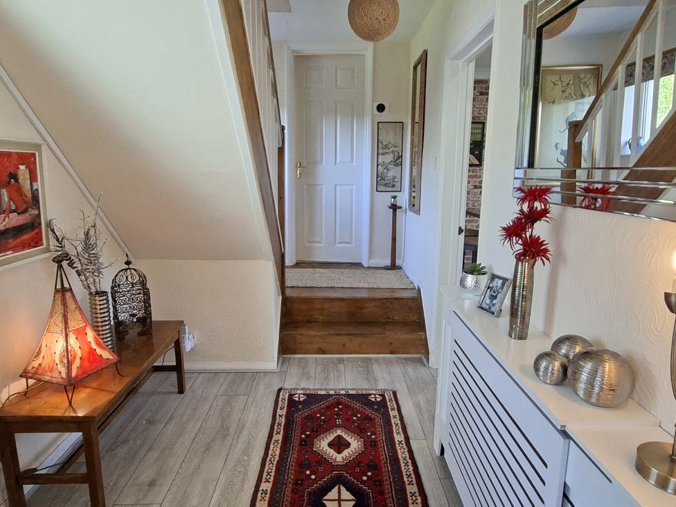 A hallway with a table and lamp at Apple Byrd in Kendal