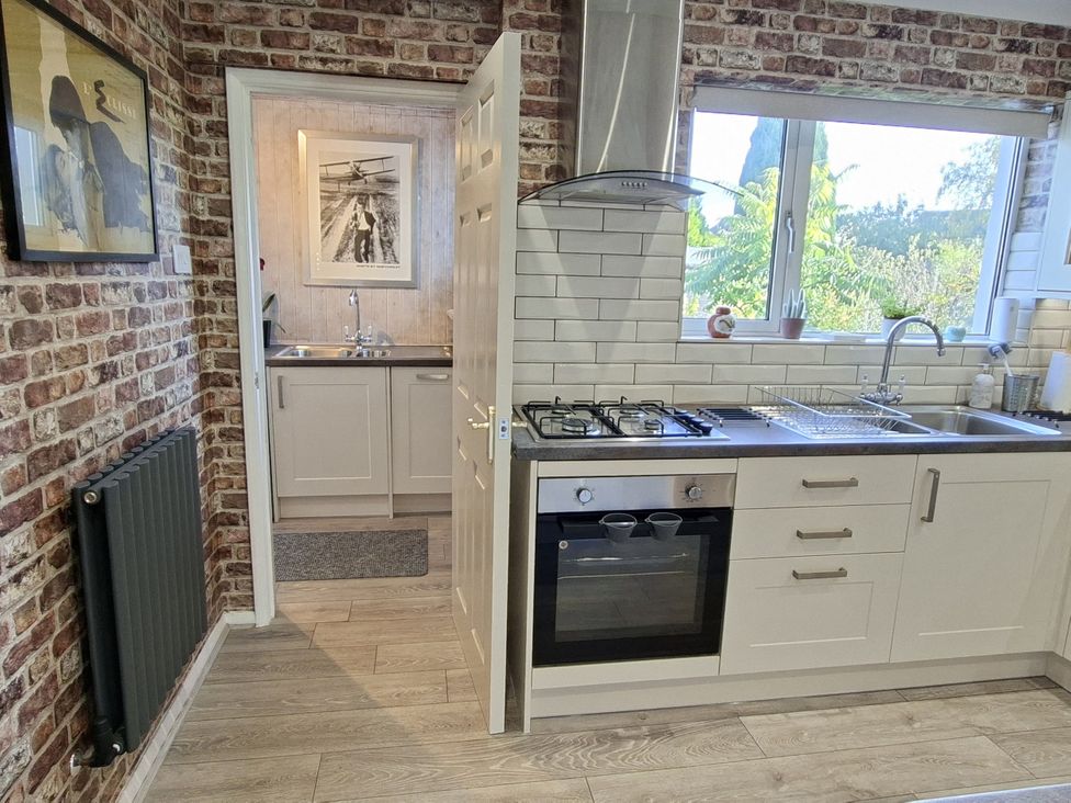 A kitchen with an oven and sink at Apple Byrd in Kendal