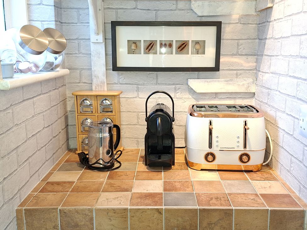 A kitchen countertop with a kettle, coffee machine, and toaster at Apple Byrd in Kendal