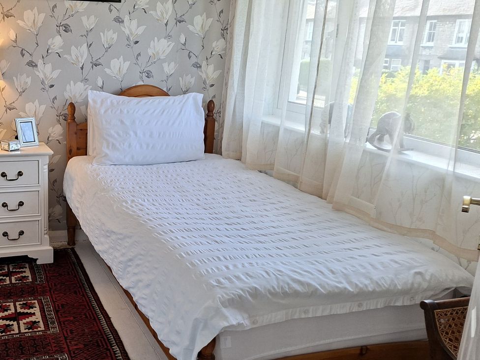 A bedroom with a bed and nightstand at Apple Byrd in Kendal