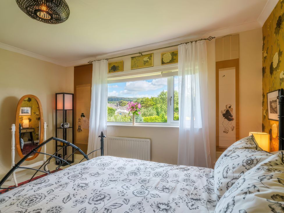 A bedroom with a bed and a window at Apple Byrd in Kendal