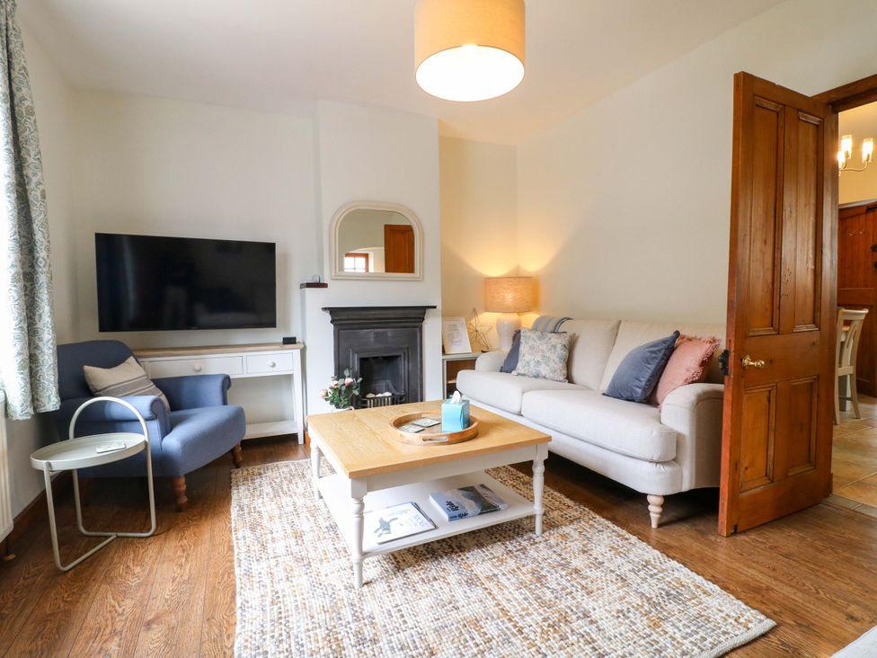 A living room with a television and sofa at 9 New Lumford