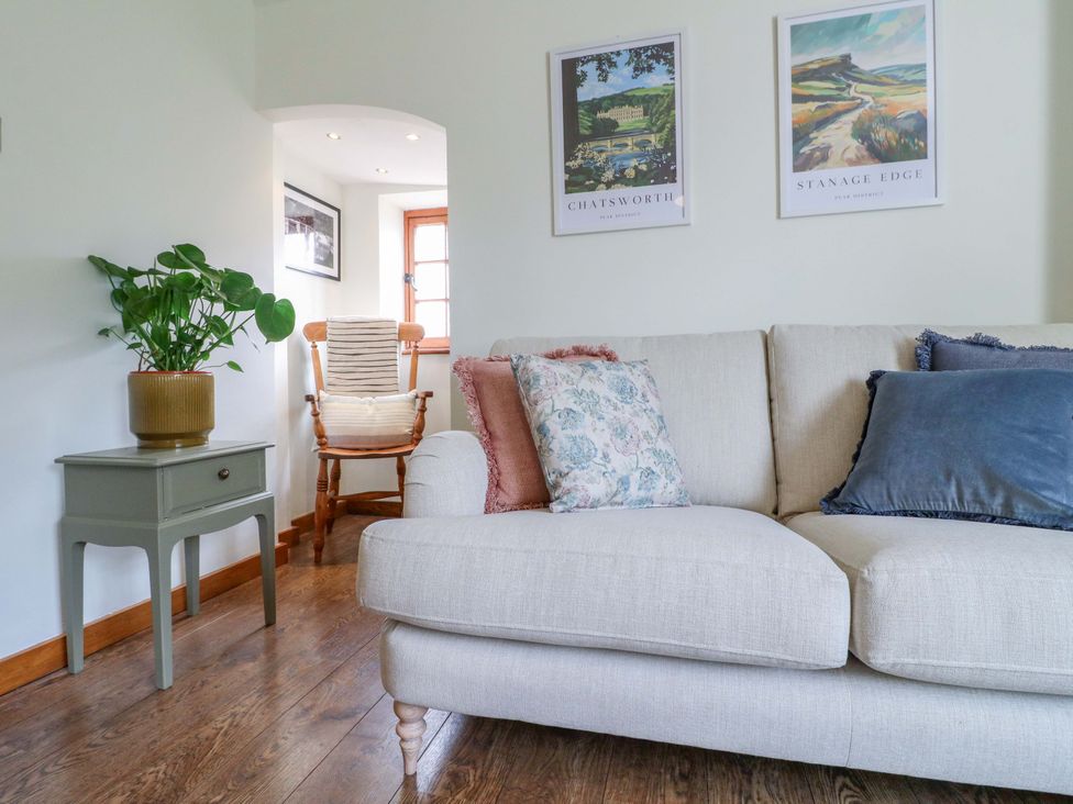 A living room with a sofa and a potted plant at 9 New Lumford