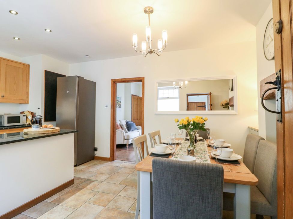 A kitchen with dining table and chairs at 9 New Lumford