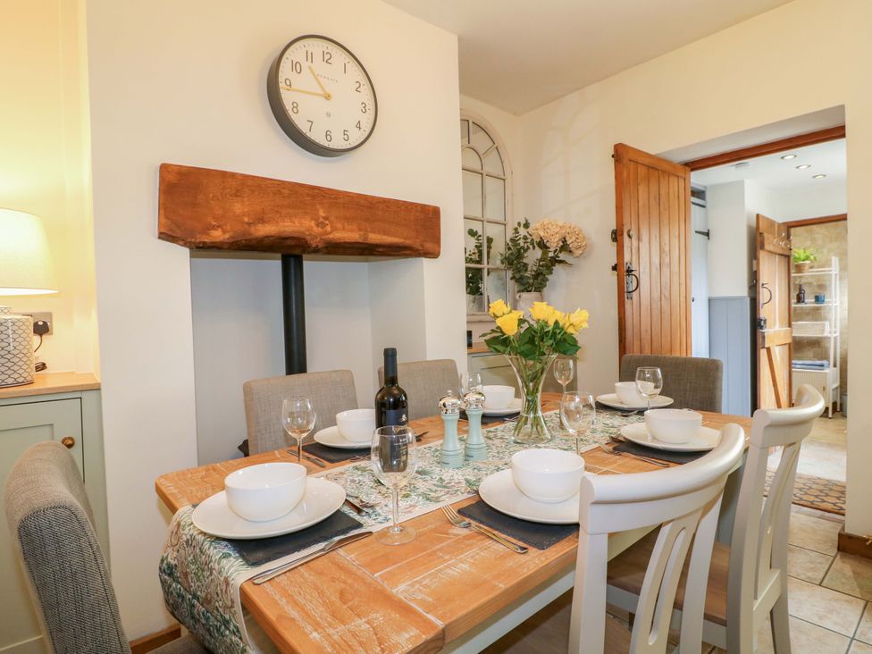 A dining room with a table set for a meal at 9 New Lumford