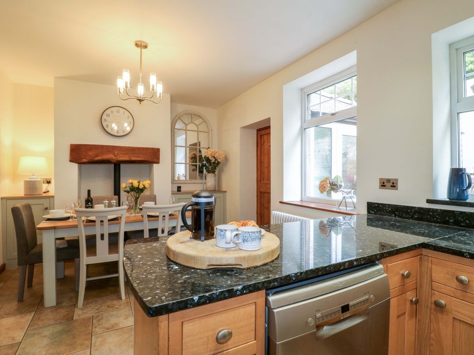 A kitchen with a dining table and chairs at 9 New Lumford