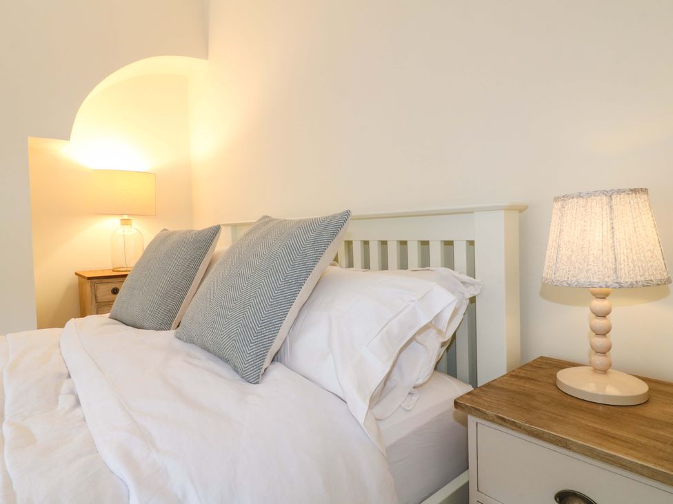 A bedroom with a bed and bedside table at 9 New Lumford 