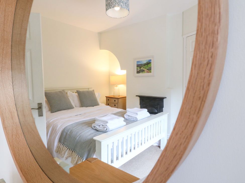 A bedroom with a bed and bedside table at 9 New Lumford