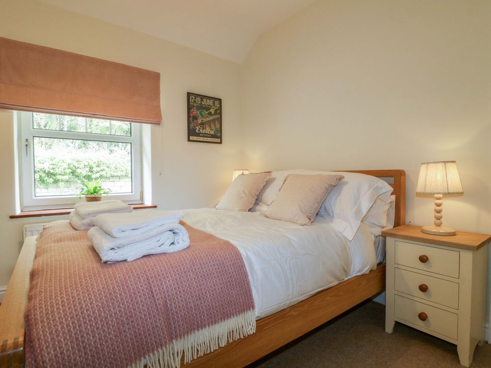 A bedroom with a bed and bedside table at 9 New Lumford 