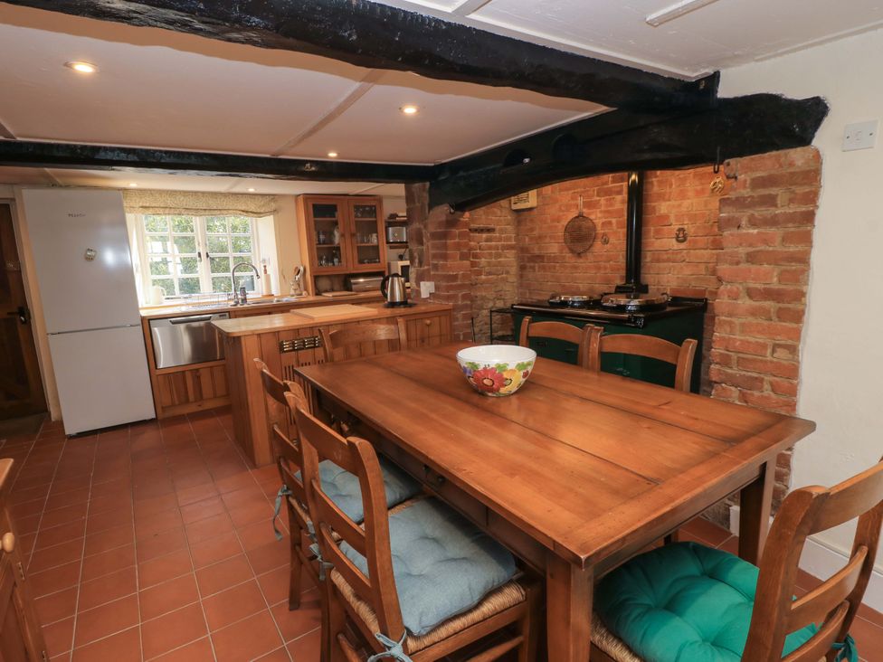 A kitchen with a table and chairs at Plush Cottage in Dorchester