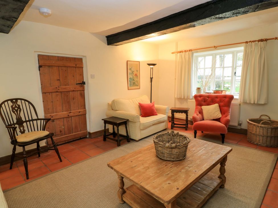 A living room with a sofa and armchair at Plush Cottage in Plush