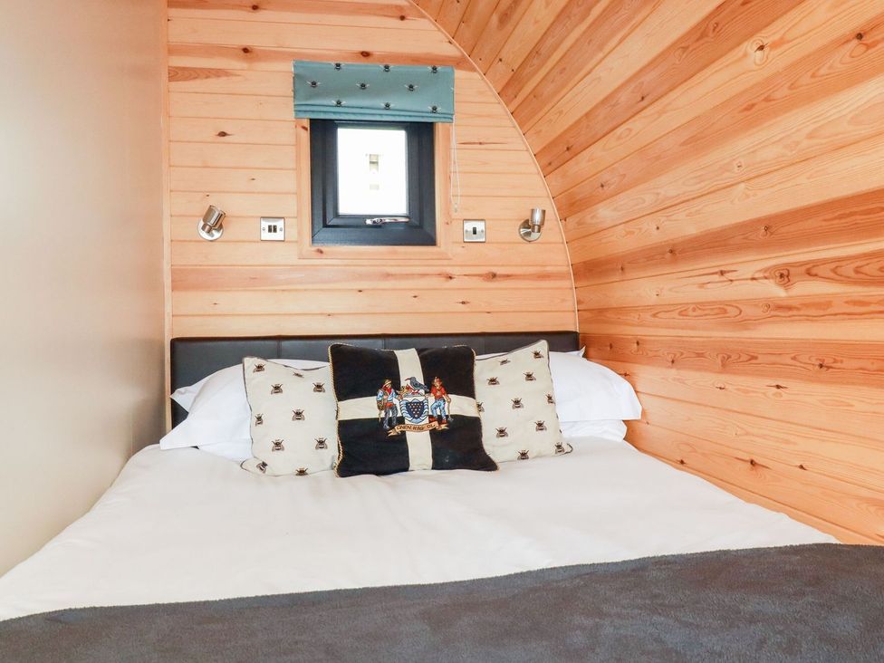 A bedroom with a bed and window at Barry in Polgooth