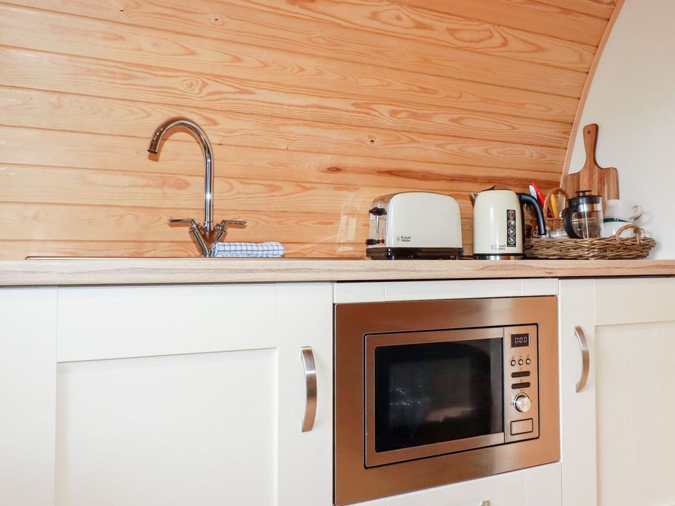 A kitchen with a sink and microwave at Sam in Polgooth