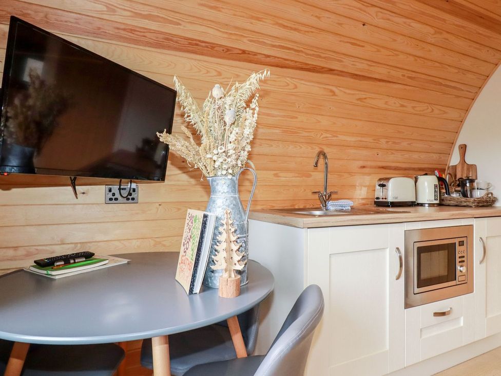 A kitchen with a table and chairs in Vic Polgooth