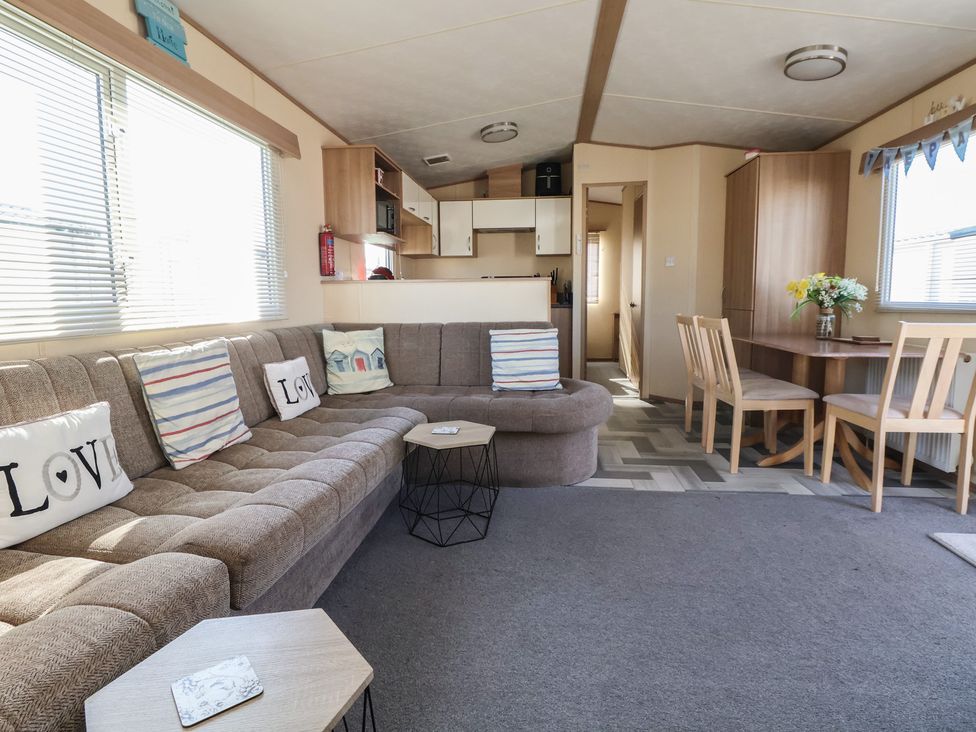 A living room with a sofa and dining table at The Pad