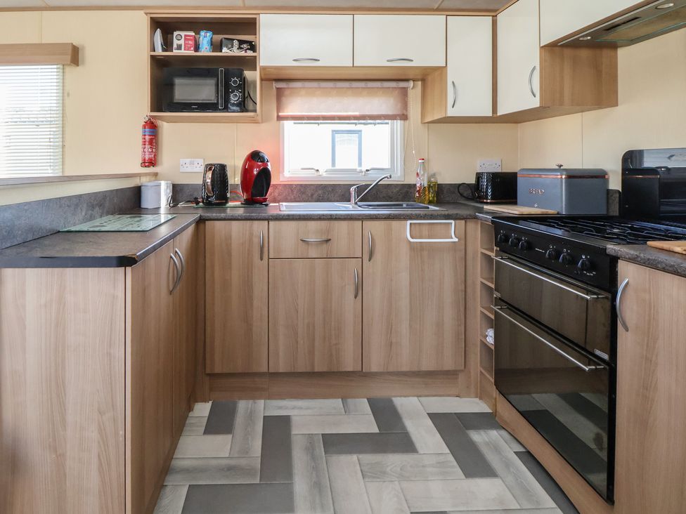 A kitchen with appliances and cabinetry at The Pad