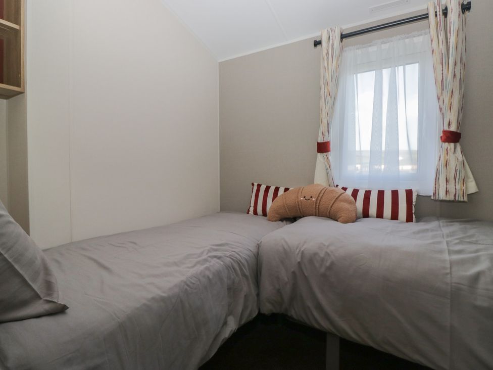 A bedroom with two single beds at Mobility Friendly Caravan St Bees