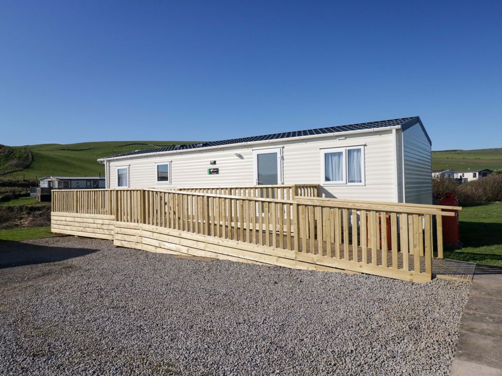A caravan with decking in front at Guillemot St Bees