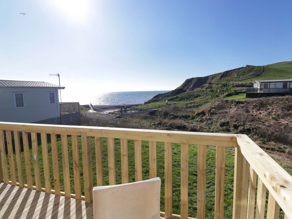 A view of the ocean and cliff from a balcony at Guillemot in St Bees