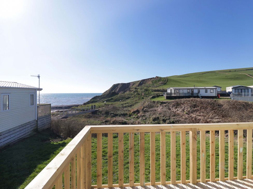 A view from a deck looking towards the sea and hills at Guillemot in St Bees