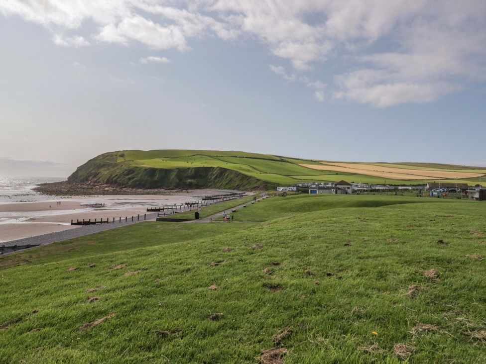 A beach with water and greenery at Guillemot in St Bees