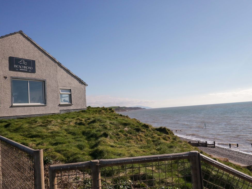 A house by the sea with a grassy area at Beachroad in St Bees