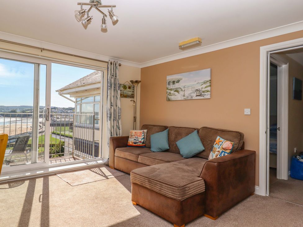 A living room with a sofa and view of the beach at Beachside