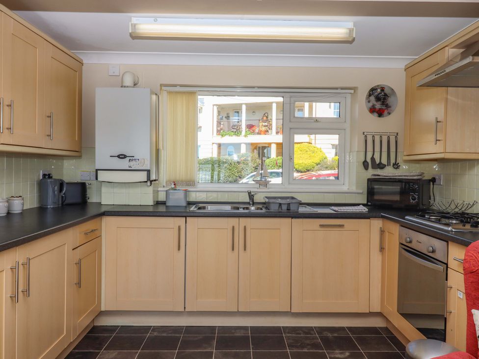 A kitchen with cabinets and appliances at Beachside