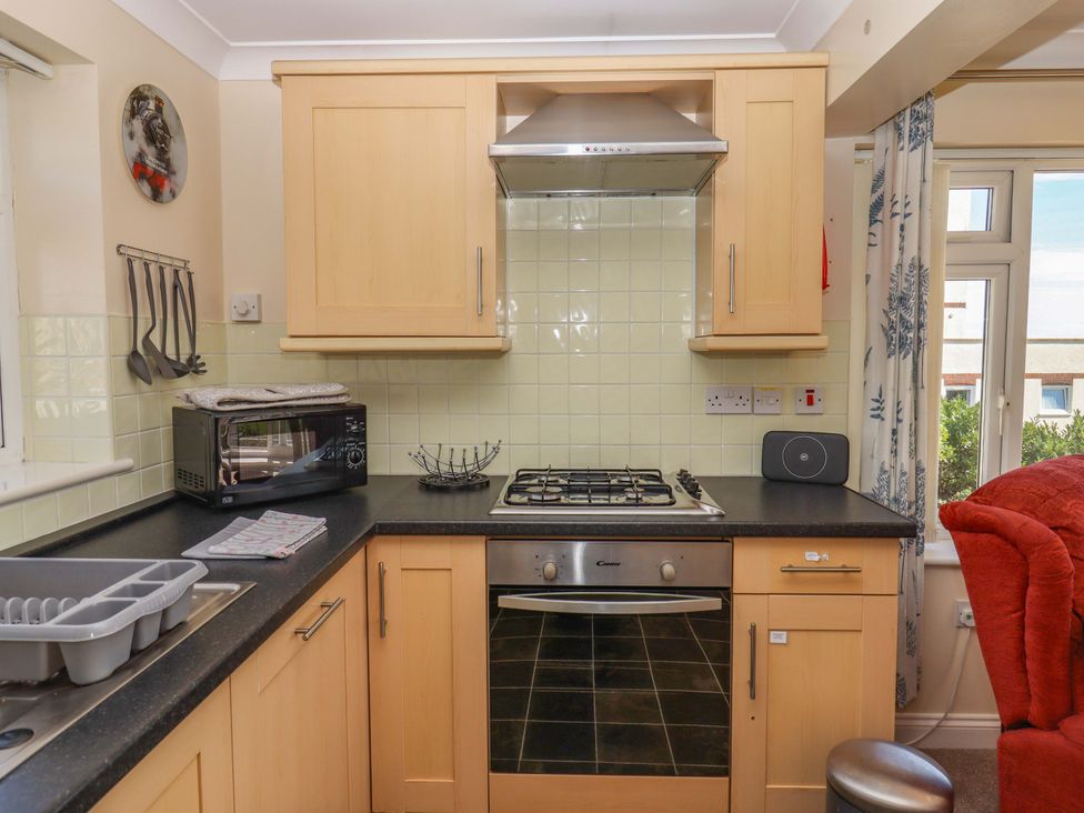 A kitchen with stove and microwave at Beachside