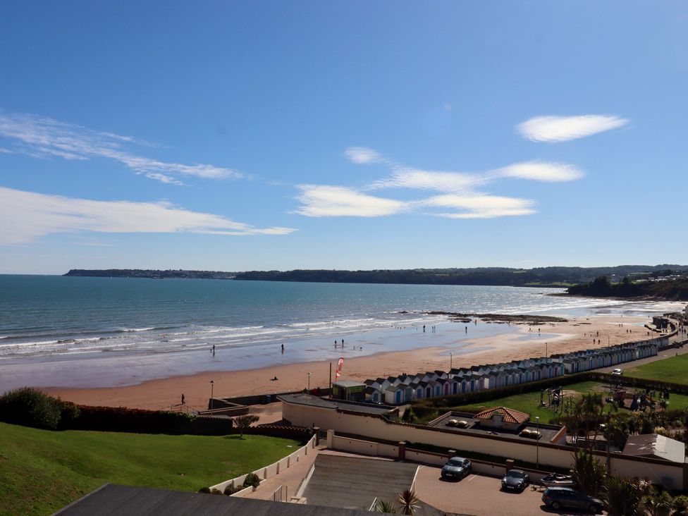 A beach with people and beach huts at Beachside in 