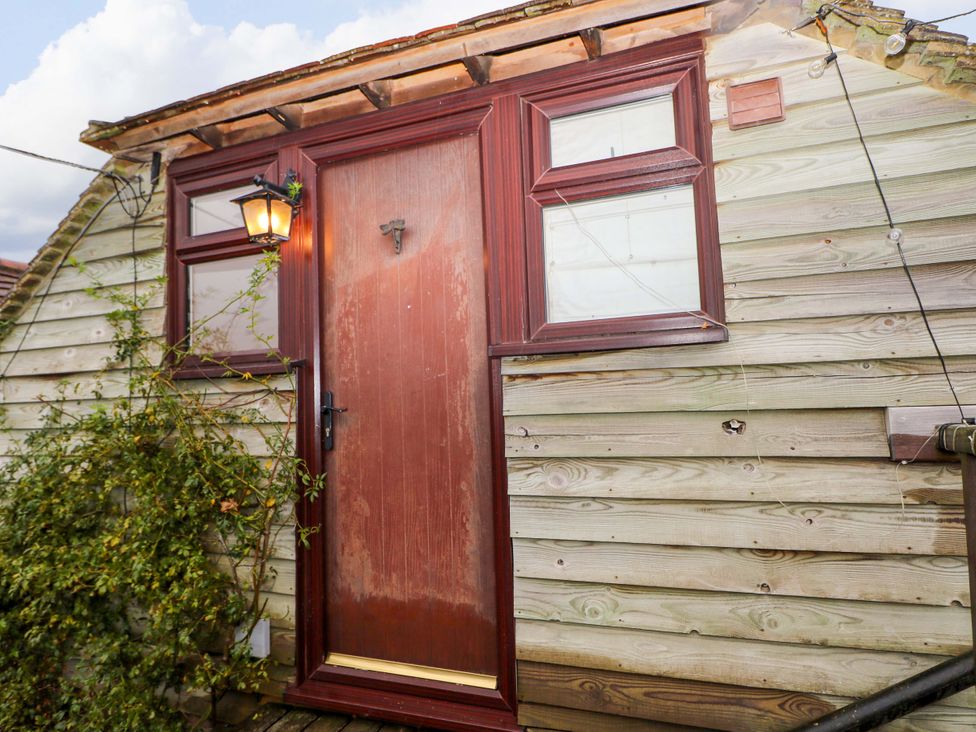 A door and window on a wooden exterior at the Annex in North Chailey near Newick