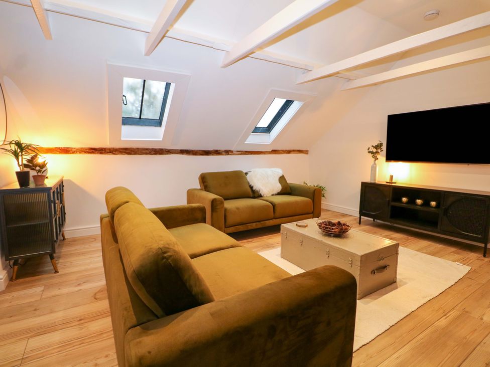 A living room with sofas and a television at Annex in North Chailey near Newick