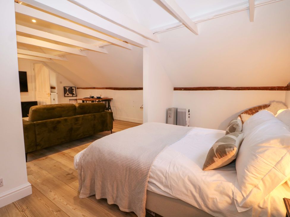 A bedroom with a bed and a sofa at Annex in North Chailey near Newick