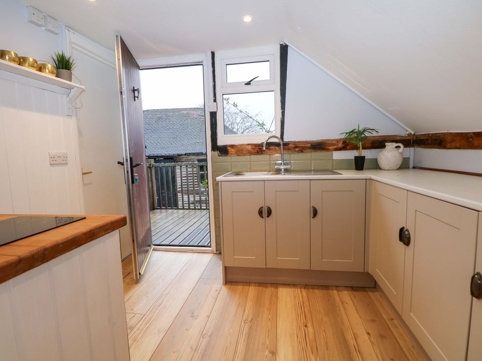 A kitchen with cabinets and a door to the outside at Annex in North Chailey near Newick