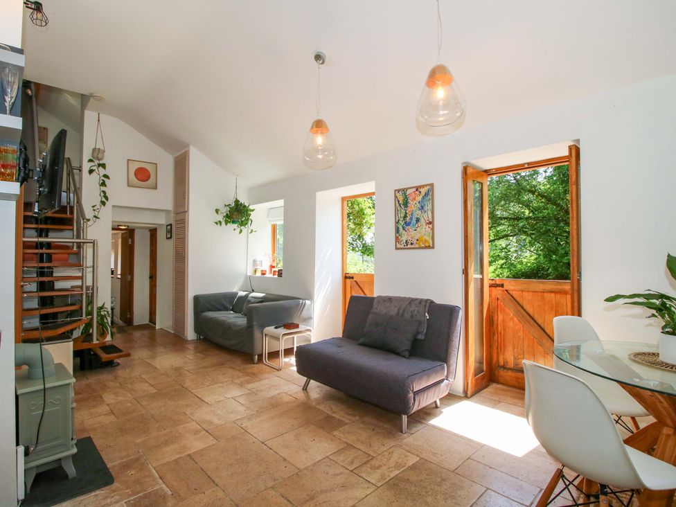 A living room with a sofa and table at The Lime Kiln Keepers Cottage in Ellesmere