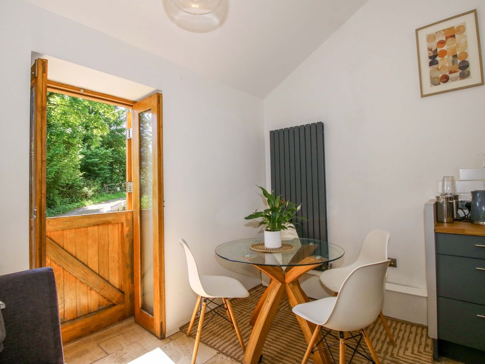 A dining room with a table and chairs at The Lime Kiln Keepers Cottage in Ellesmere
