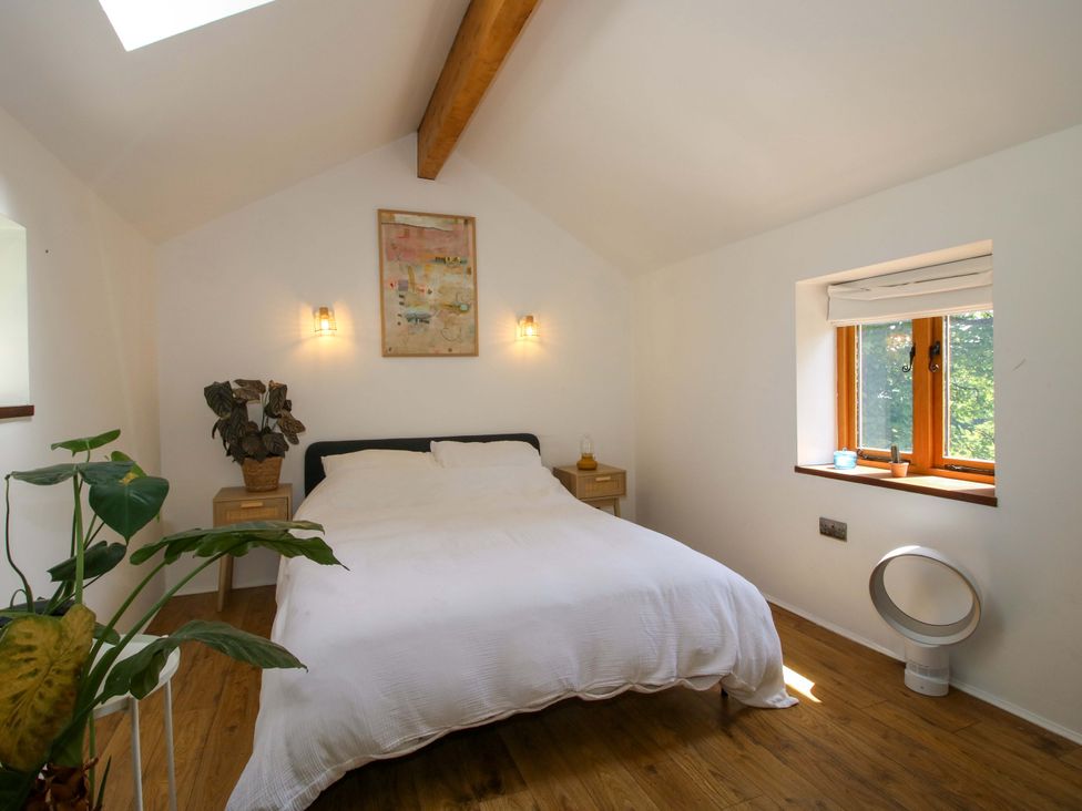 A bedroom with a bed and a plant at The Lime Kiln Keepers Cottage in Ellesmere